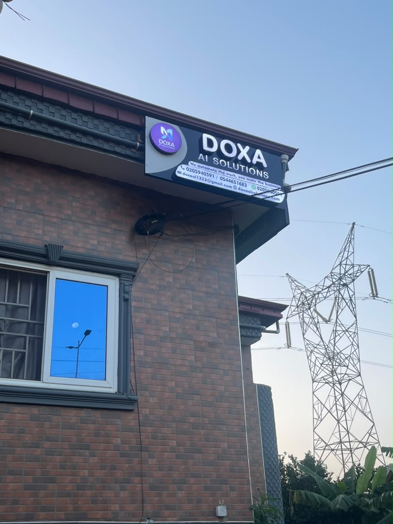 Doxa AI Solutions office signboard on Ayawaso Road, Accra